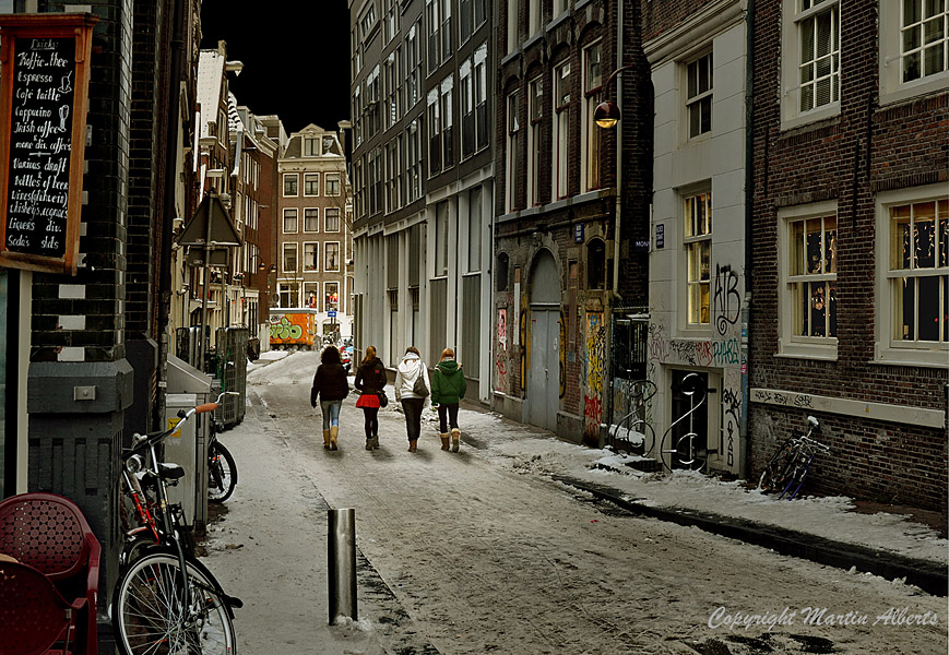 Bloedstraat Amsterdam. Four schoolgirls walking through a Red Light District street.