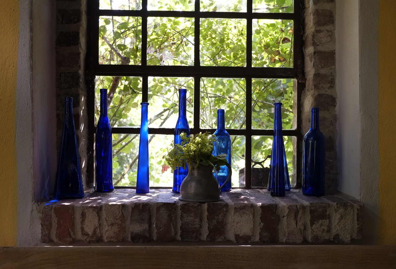 blue glass and green leaves