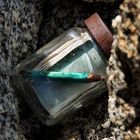 blue pencil in glass jar register on mountain peak