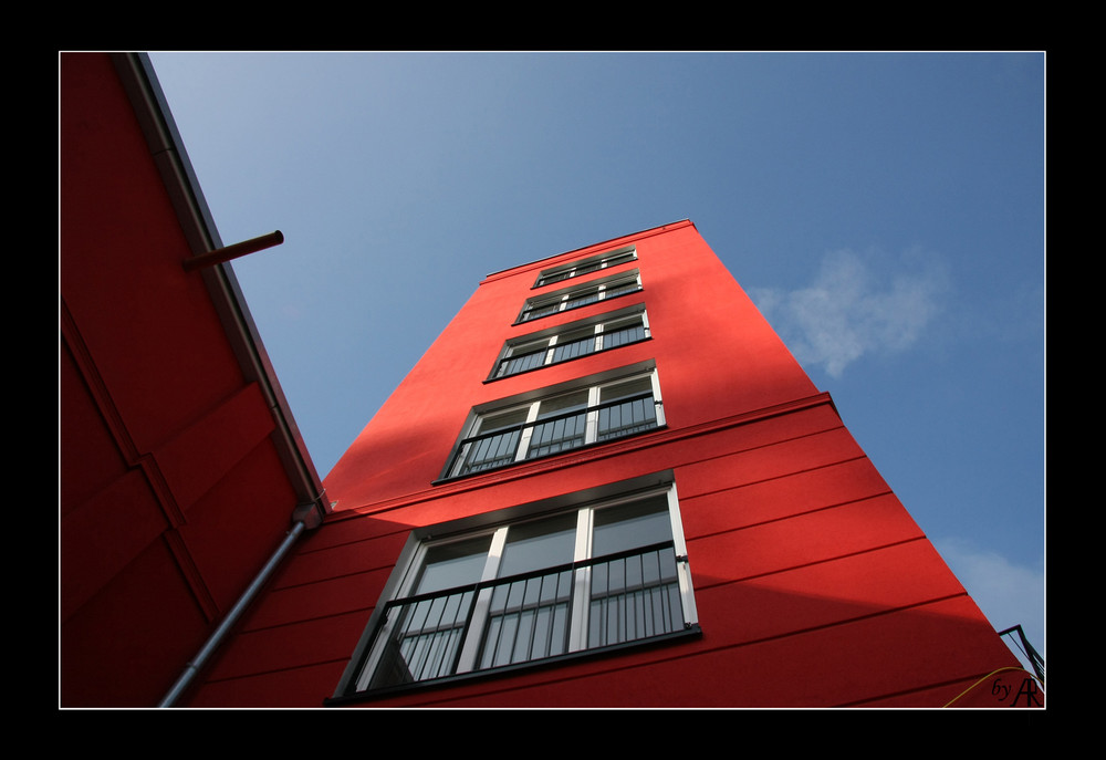 --- blue sky behind red building ---
