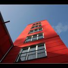 --- blue sky behind red building ---