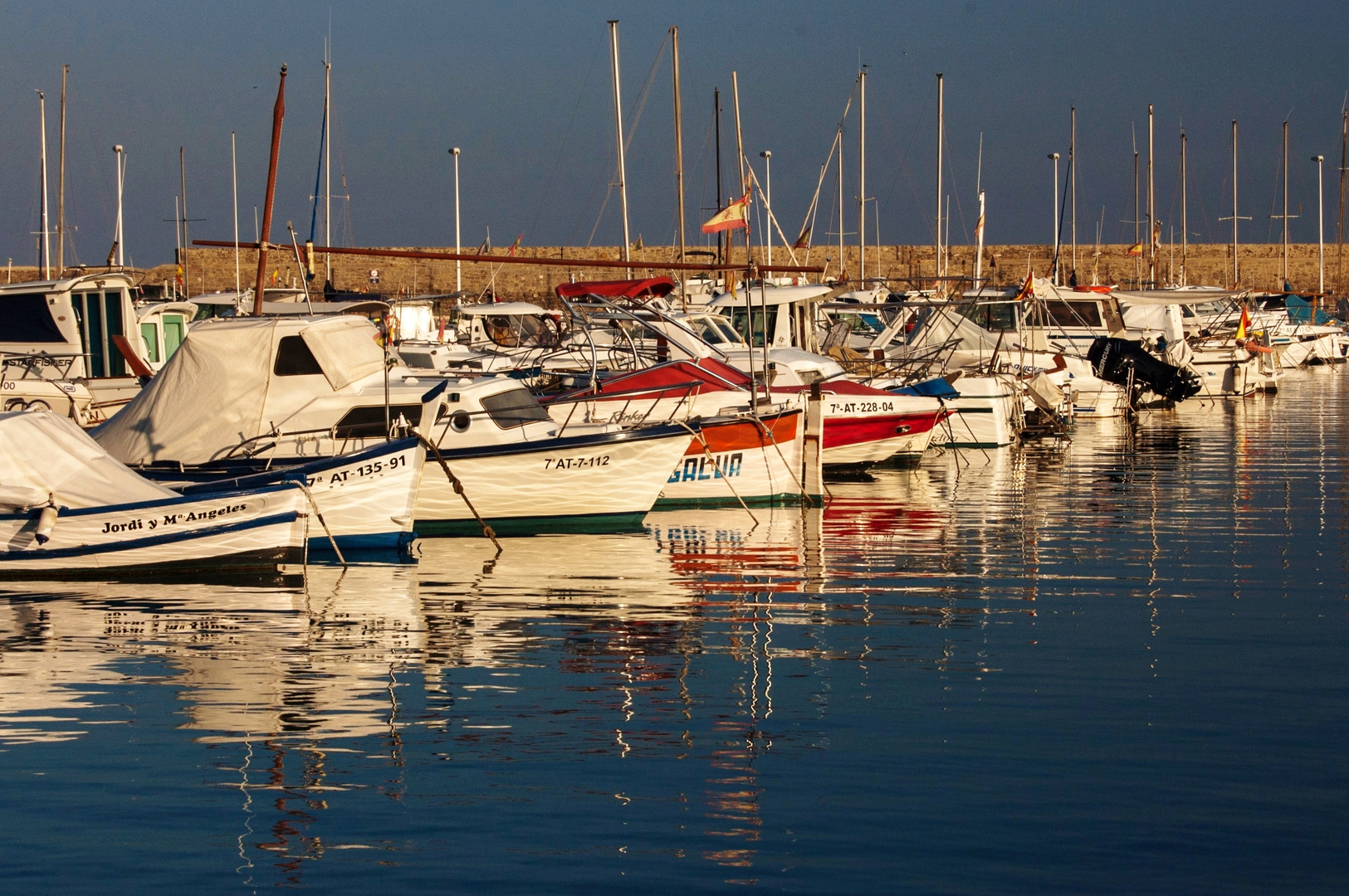 boats docked at sunset