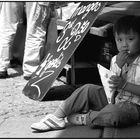 Boy at market eating french fried