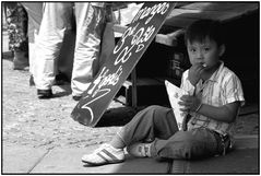 Boy at market eating french fried