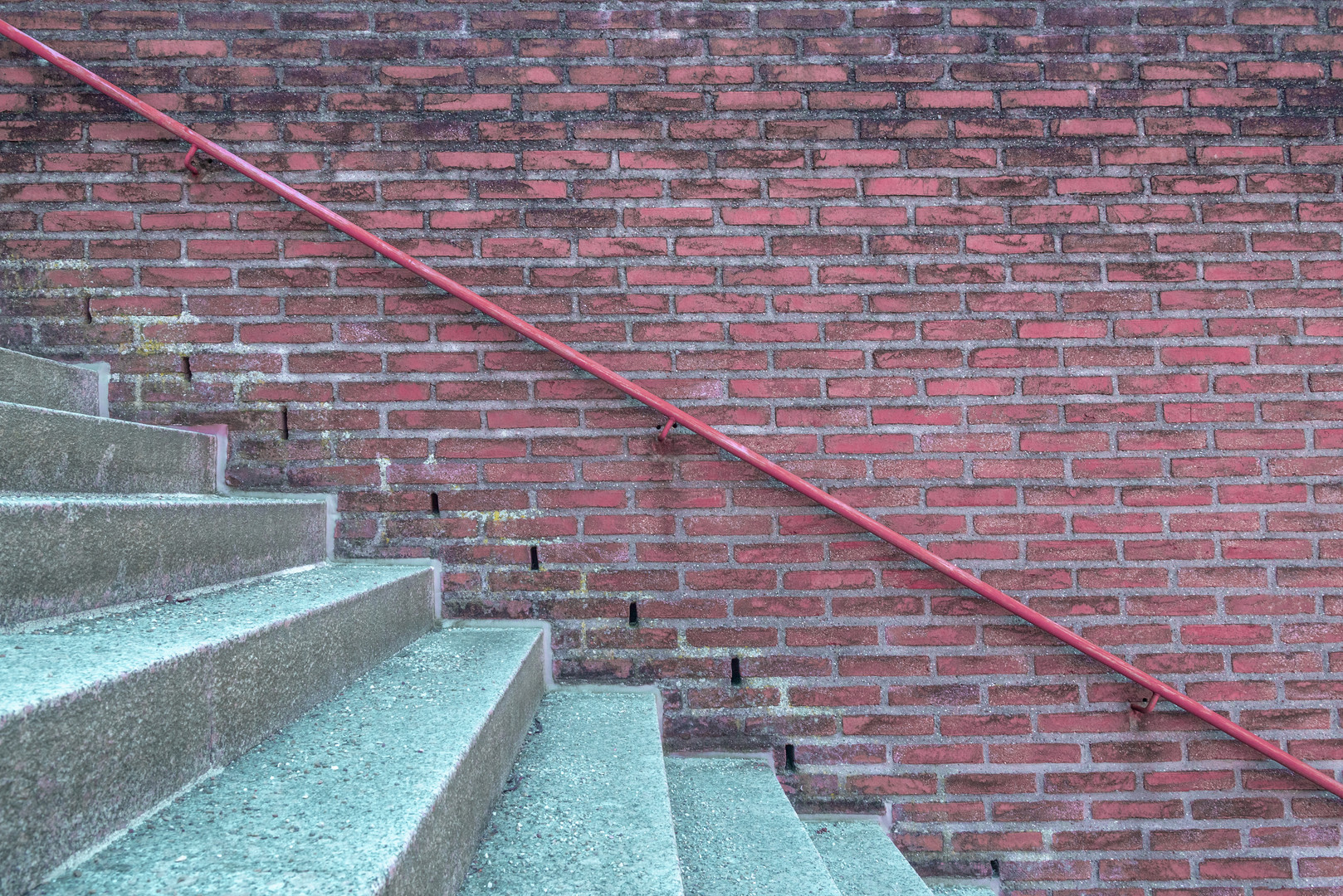 Brick wall with handrail and stairs