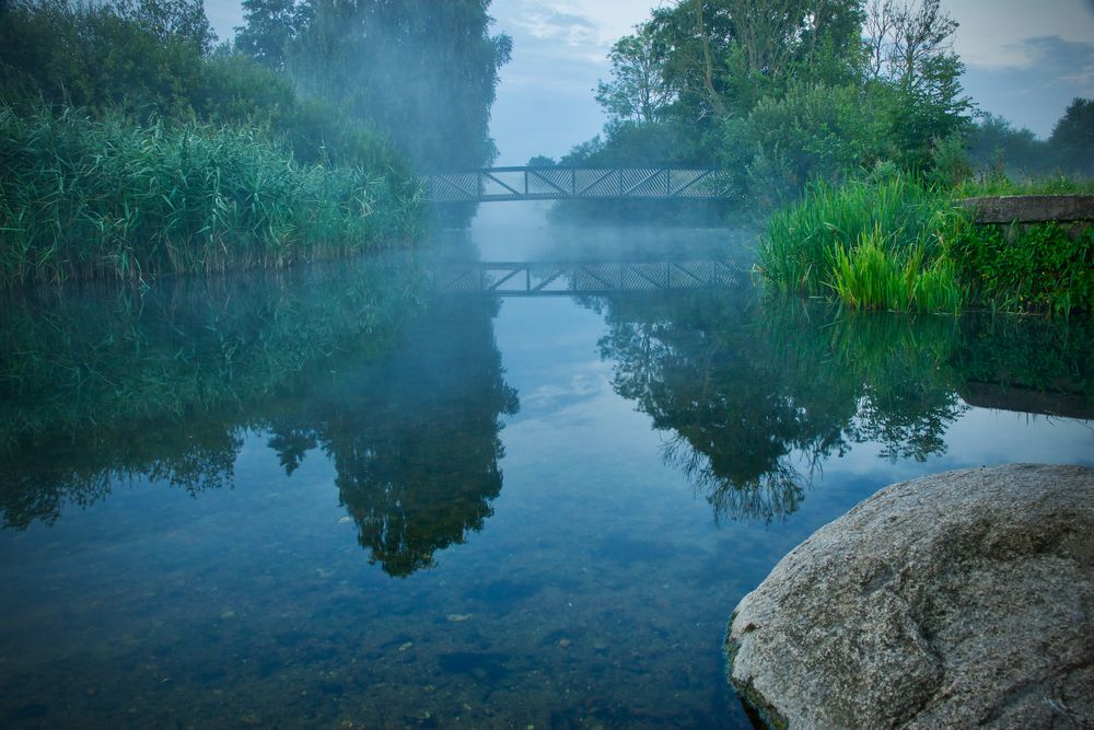 Bridge over foggy water