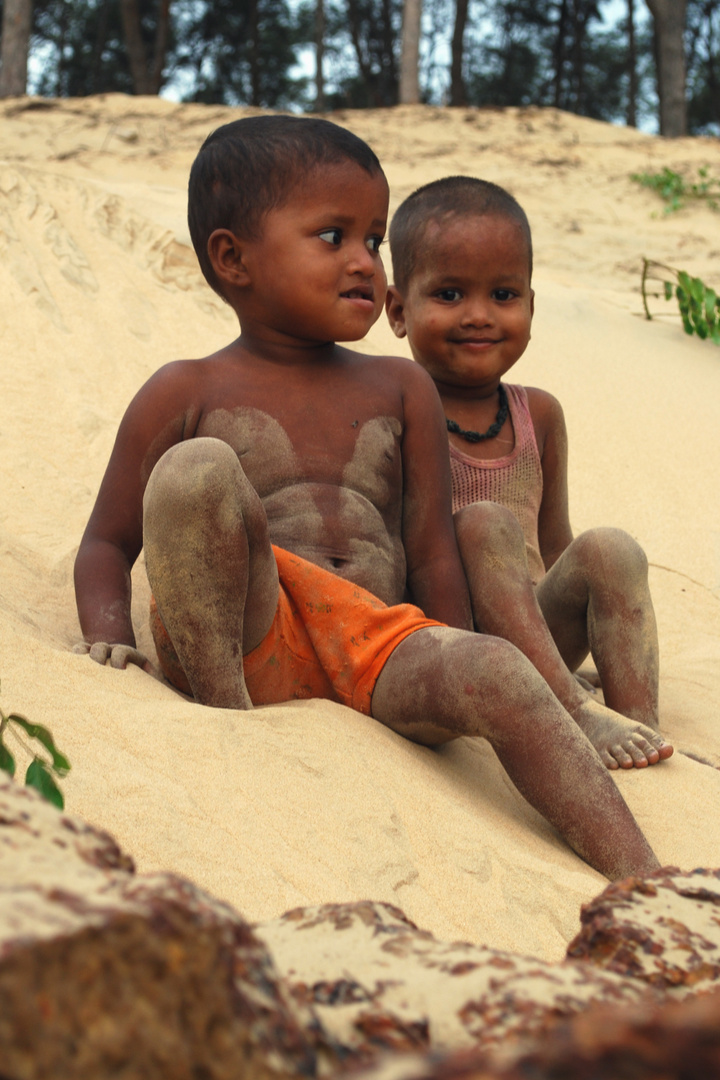 brothers playing with sand