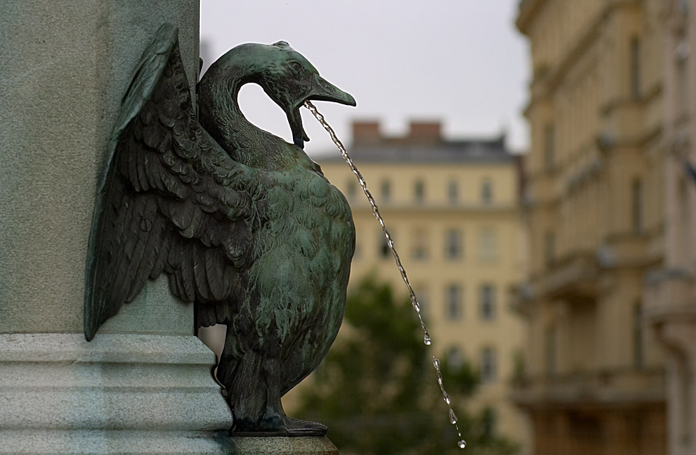 Brunnenfigur vor grauem Himmel