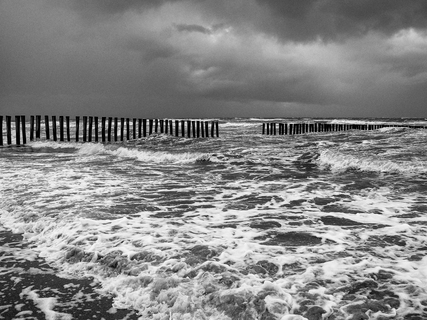 Buhnen und aufgewühltes Meer