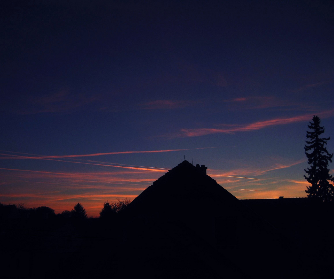 Bunter Himmel mit Flugzeugstreifen.