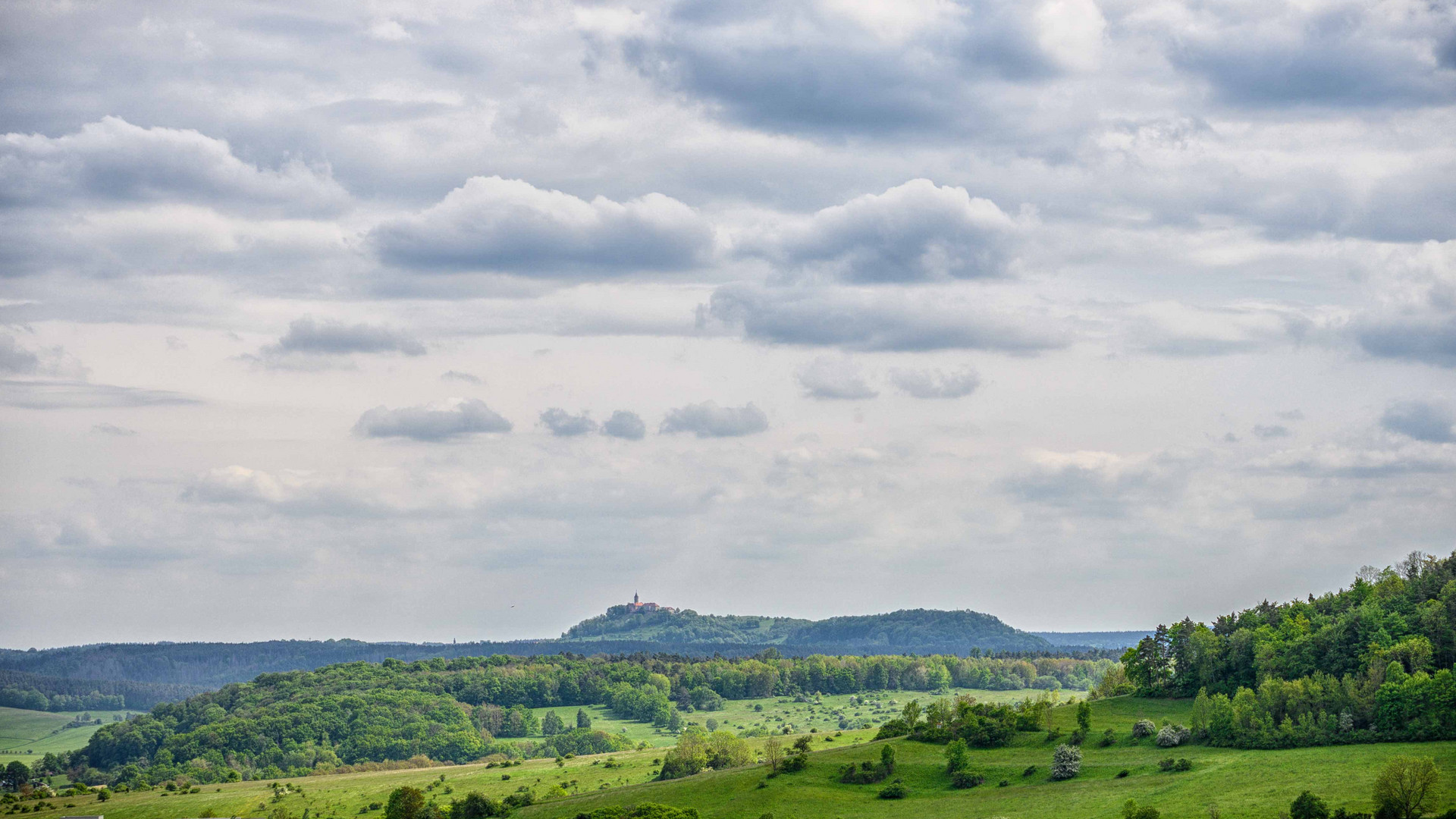 Burg in mitten einer Hügellandschaft