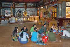 Burmese family enjoy a lunch picknick on the floor