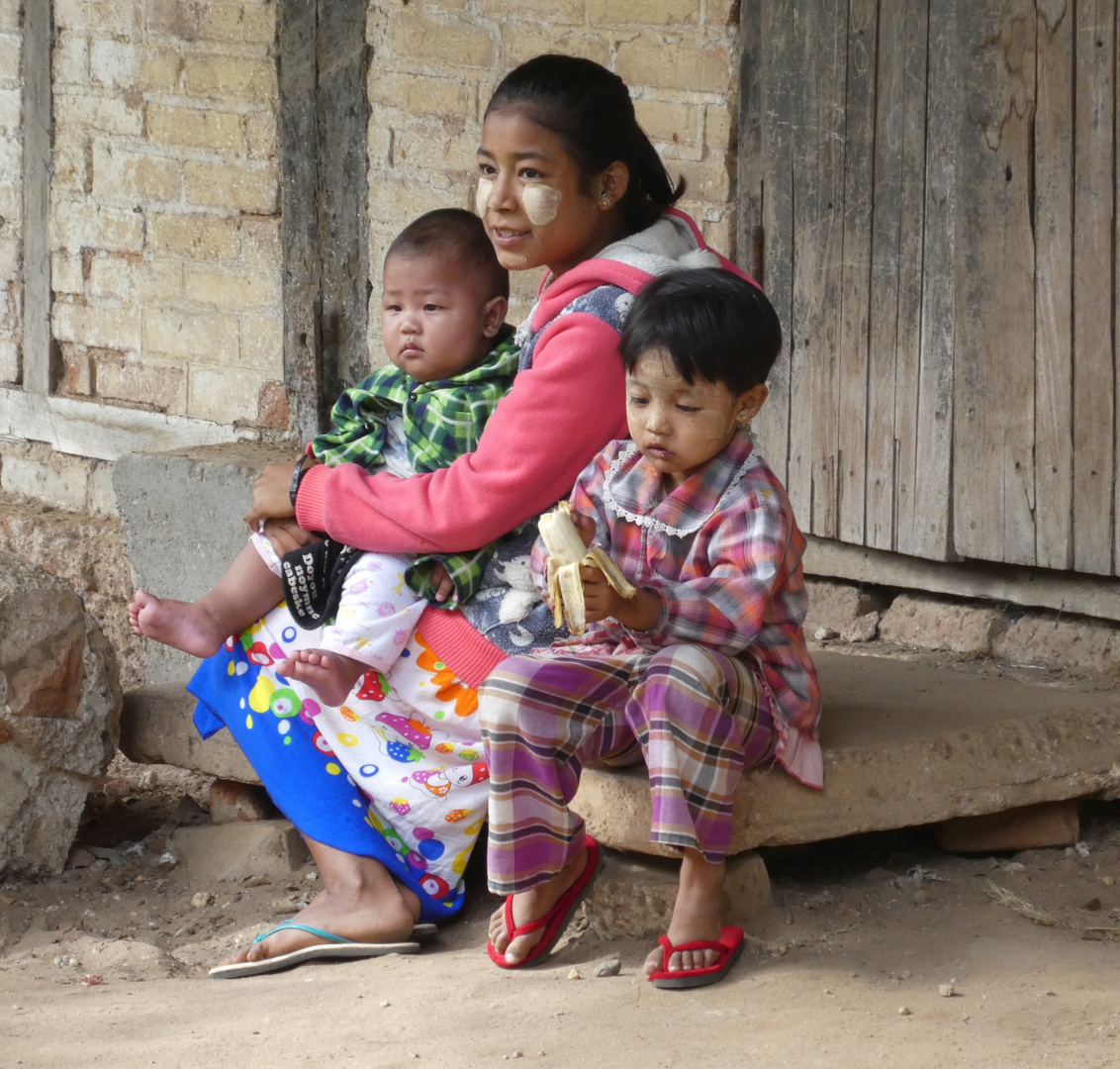 Burmese family with thanaka make-up