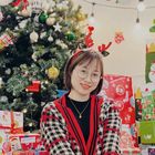 Captivating Moment of A Woman by the Christmas Tree