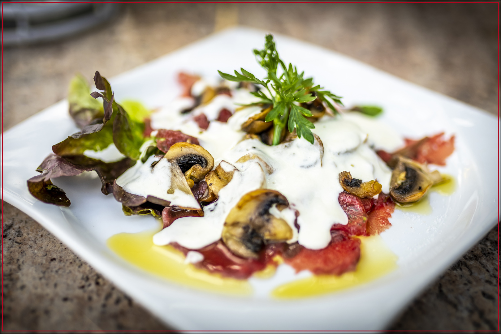 Carpaccio di Manzo con Funghi e Crema di Grana...