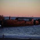 cement ship at sunset - end of days