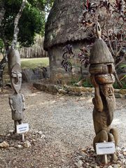 Centre culturel Tchibaou - Poteaux sculptés devant une case traditionnelle