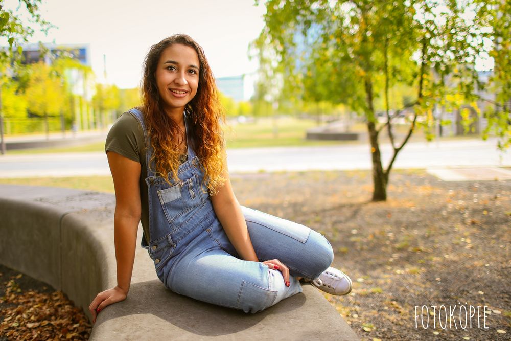 Charleen sitting on a wall