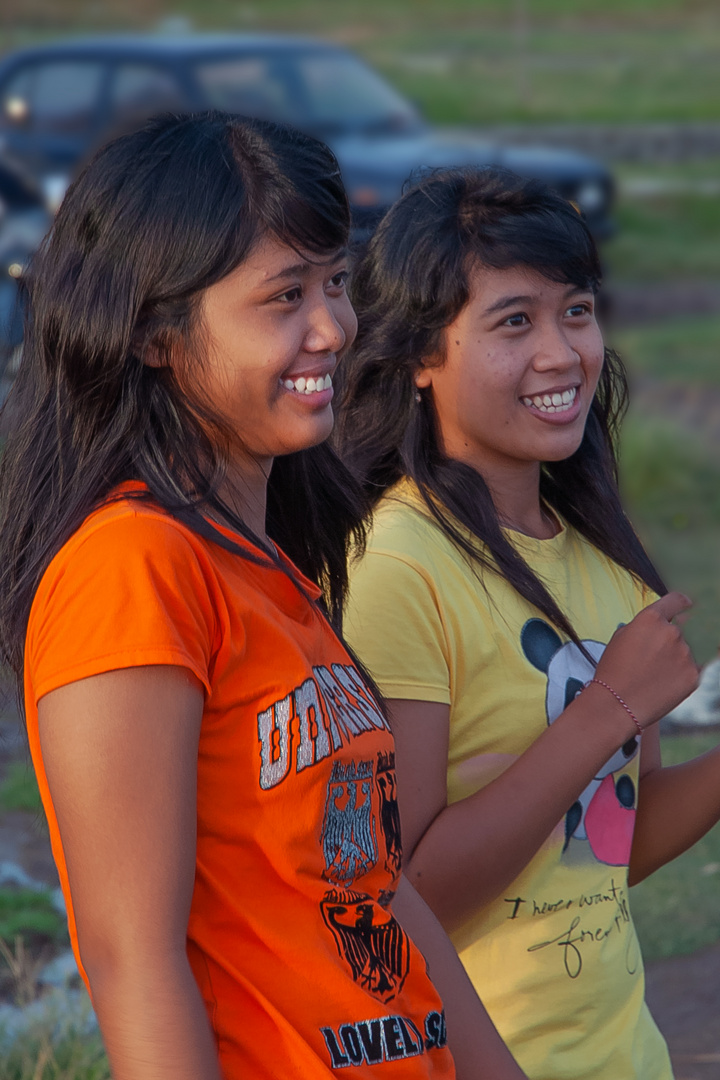 Charming smiling Balinese sisters