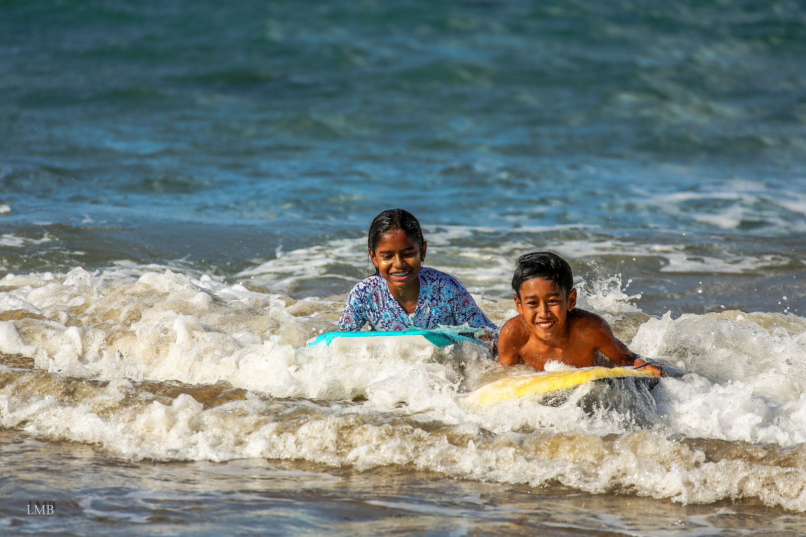 Children happiness in the waves