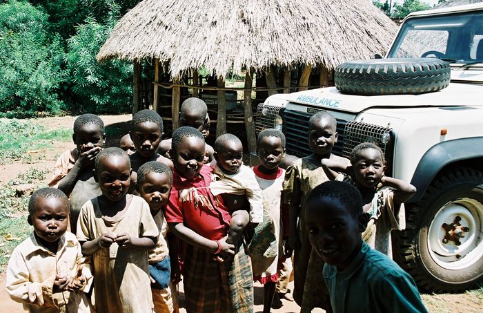 children in front of an ambulance