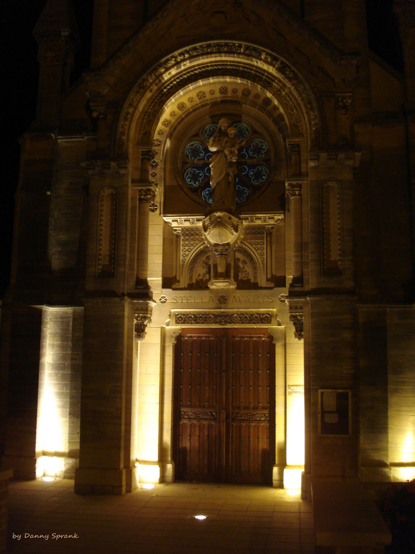 church at night in Arromanches