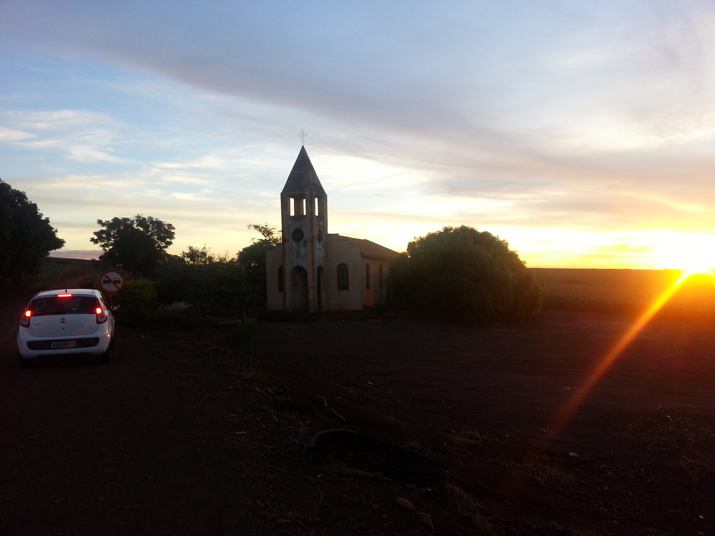 church, sunset, car with back lights