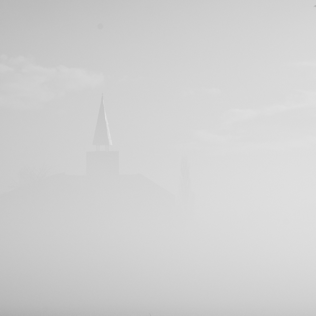 Churchtower in the mist.