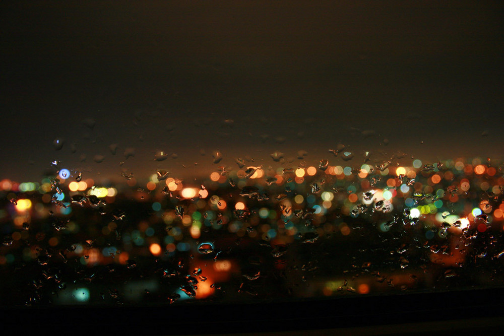 City lights behind the raindrops