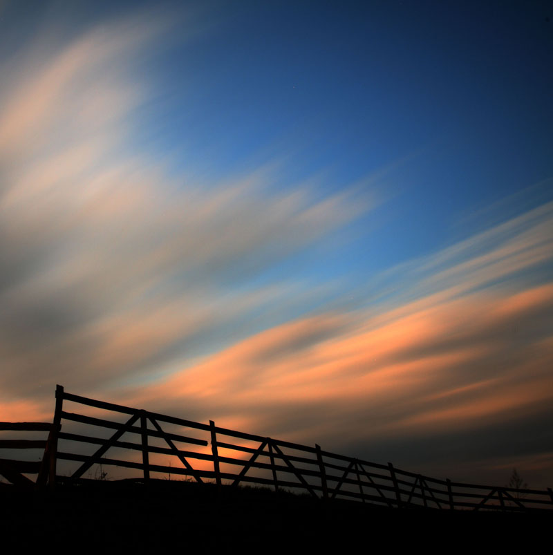 Clouds over fence