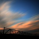 Clouds over fence