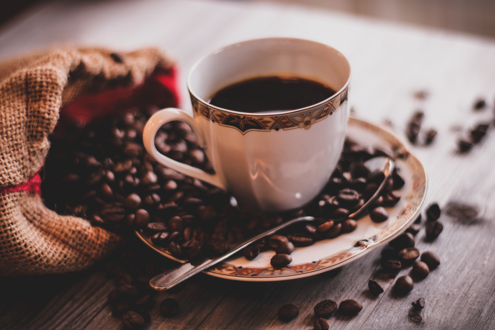 Coffe cup with beans surrounded