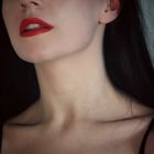 Collarbones, shadows and red lips