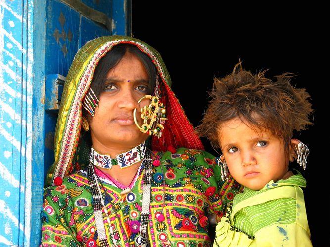 Colourful woman and child in the desert
