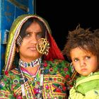 Colourful woman and child in the desert