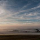 [ countryside engulfed in fog ]