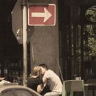 Couple Kissing At Street Cafe