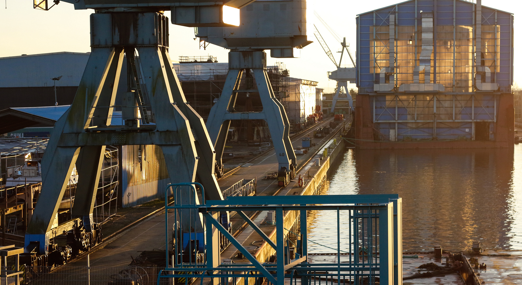 cranes and dock against the light