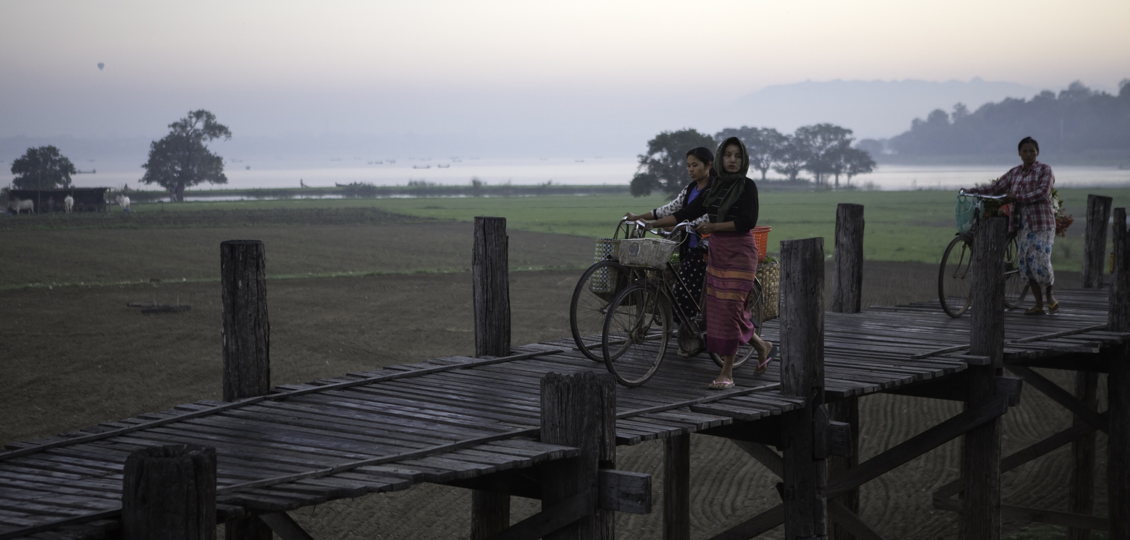 [ …crossing U Bein Bridge ]