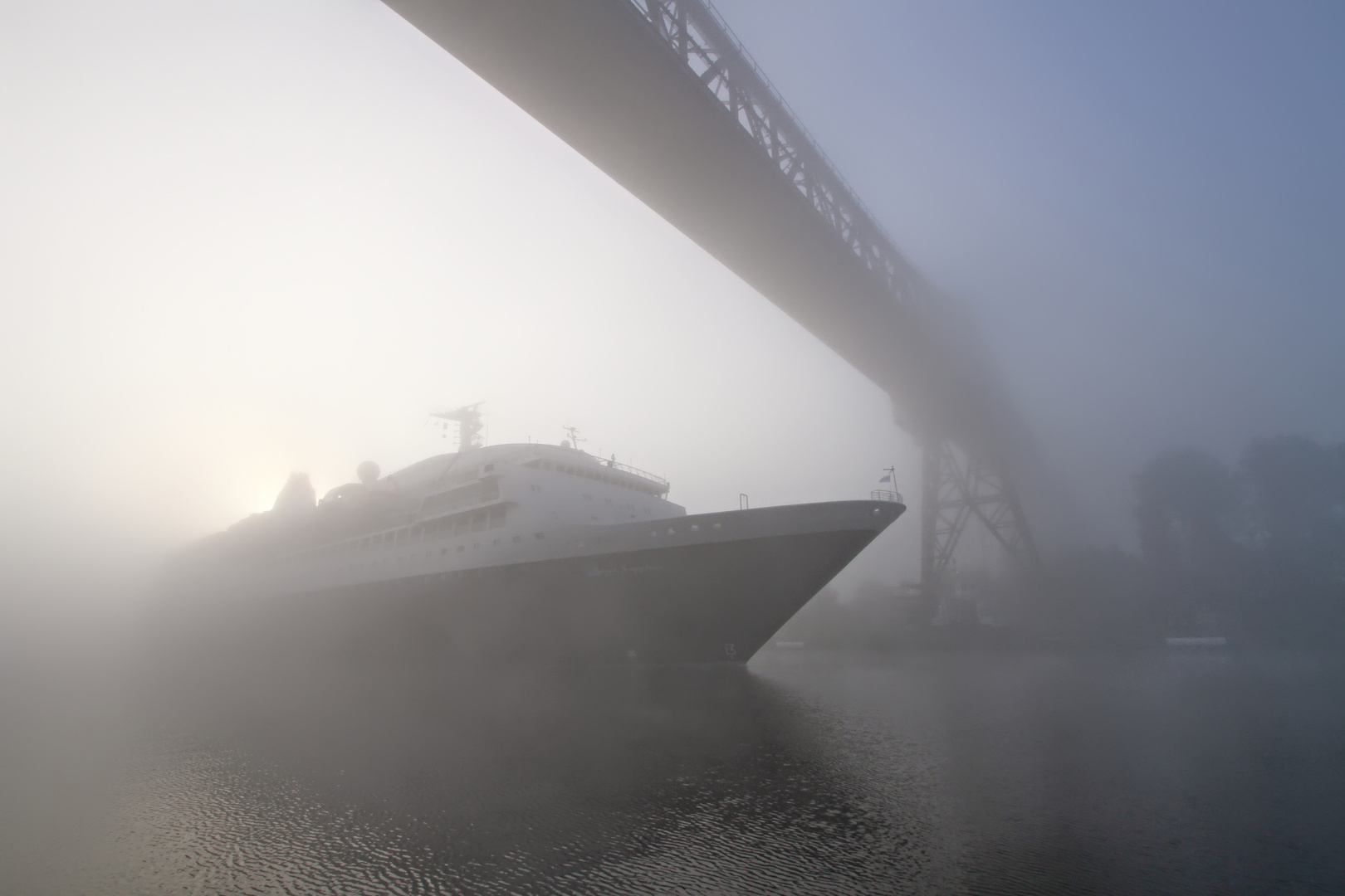 cruise ship at sunrise below railwaybridge Rendsburg