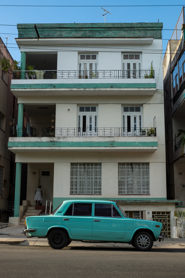Cuban car in front of house