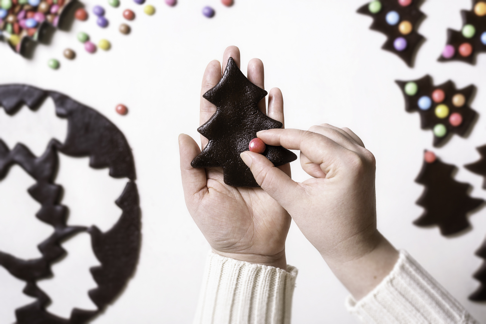 Decorating Christmas cookies with colorful candies. Gingerbread