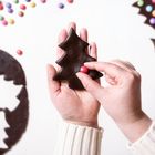 Decorating Christmas cookies with colorful candies. Gingerbread