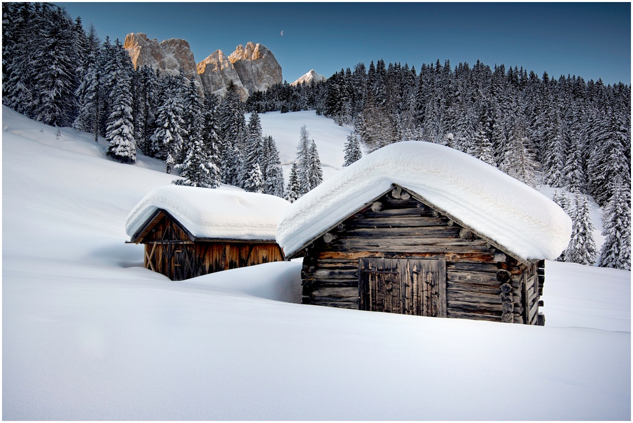 Deep now-covered Alpine huts