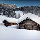 Deep now-covered Alpine huts