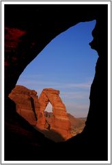 Delicate arch through window frame