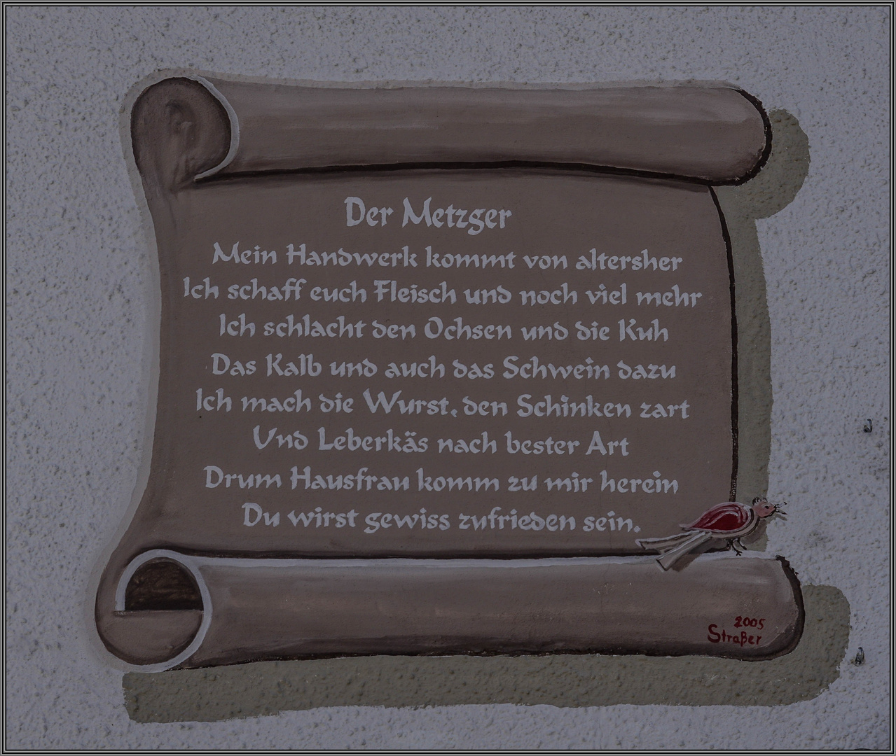 Ein Gebäude mit dem witzigen Spruch &lsquo;Der Metzger - Wir zerlegen auch Ihr Sparschwein&rsquo;