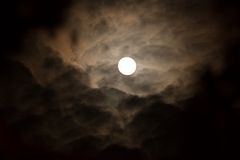 Der Mond umgeben von dichten Wolken