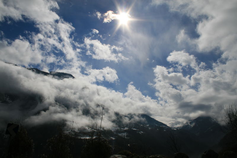 Des nuages en bas de la montagne ensoleillée