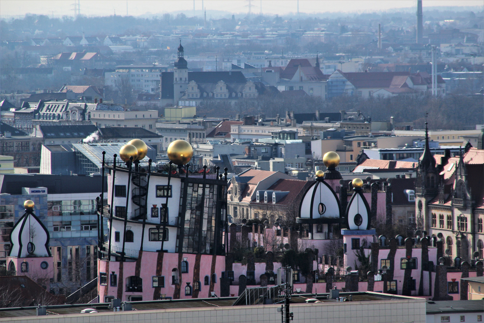 Die Grüne Zitadelle - das Hundertwasserhaus - in Magdeburg, im Hintergrund der Justizpalast